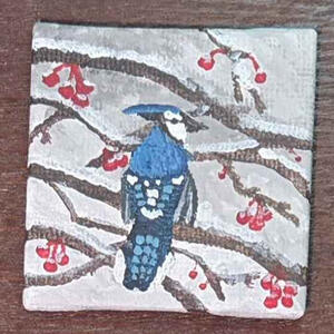 A small painting of a blue jay facing away from the viewer. It is sitting on a branch and there are small red berries on the twigs.