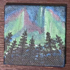 A small painting of an aurora borealis behind some trees.